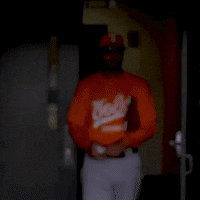 a man wearing an orange shirt that says vols baseball on it