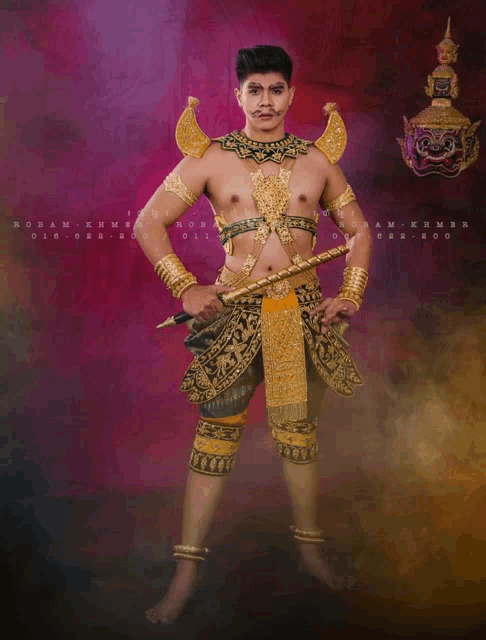 a man in a gold and black costume is standing in front of a sign that says october 2020