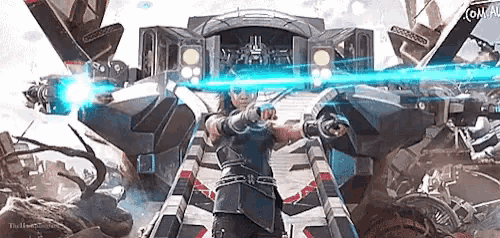 a man is standing in front of a robot with a blue light coming out of his eyes .
