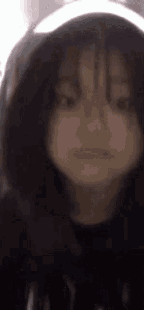 a close up of a person wearing a hoodie and making a funny face .