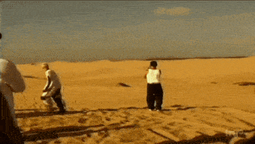 a blurry picture of people running in the desert with the words true on the bottom left
