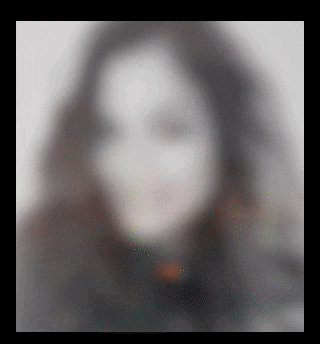 a blurred image of a woman 's face with a black background