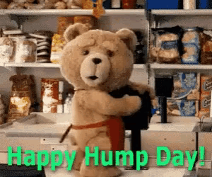 a teddy bear wearing an apron is hugging another teddy bear in a kitchen .
