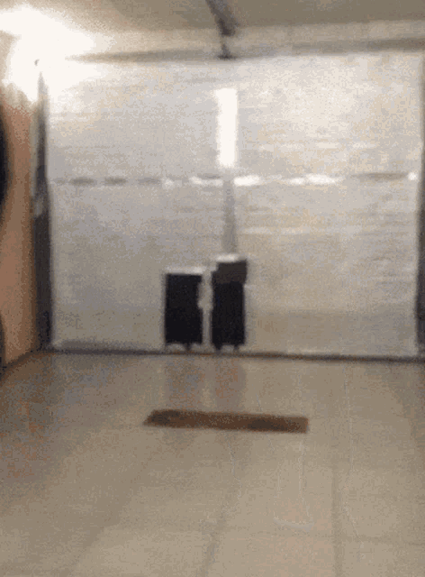 a garage door is open with a few boxes in it