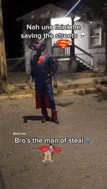 a man in a superman costume is standing on the street