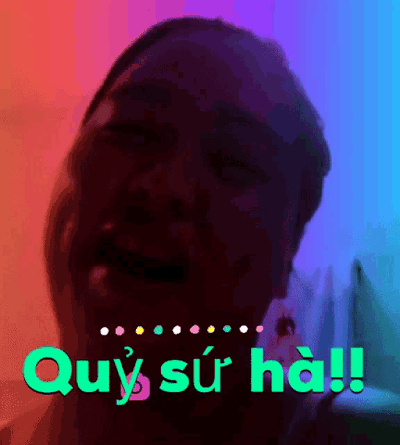 a woman is crying in front of a colorful background with the words quy su ha