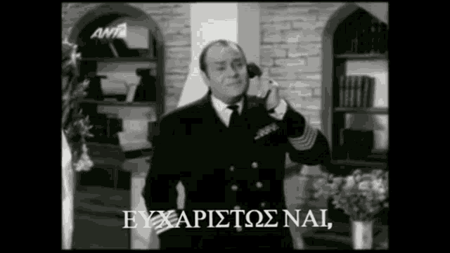 a black and white photo of a man talking on a phone with a foreign language caption