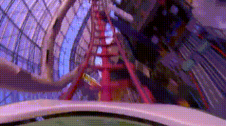 a roller coaster is going through a building with lots of windows