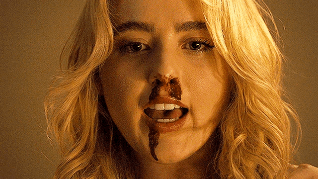 a close up of a woman with blood coming out of her nose