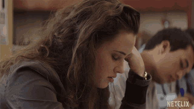 a girl sits at a desk with a netflix logo on the bottom