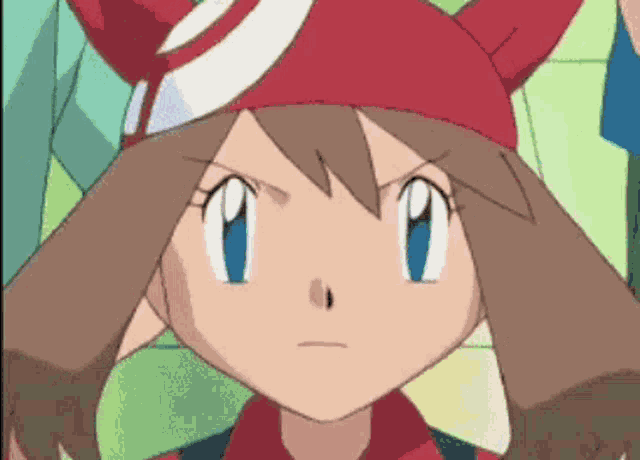a close up of a cartoon character with a red hat and blue eyes