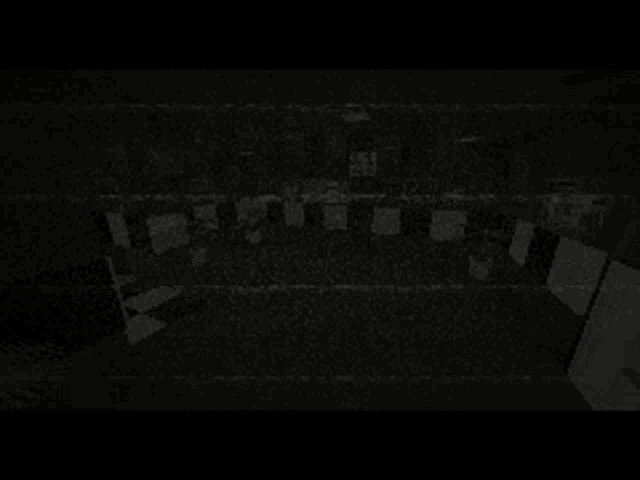 a black and white image of a dark room with a lot of noise and grain .