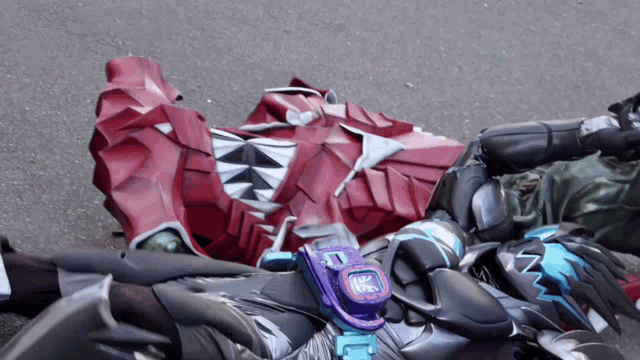 a robot with a watch that says ' samurai ' on it is laying on the ground