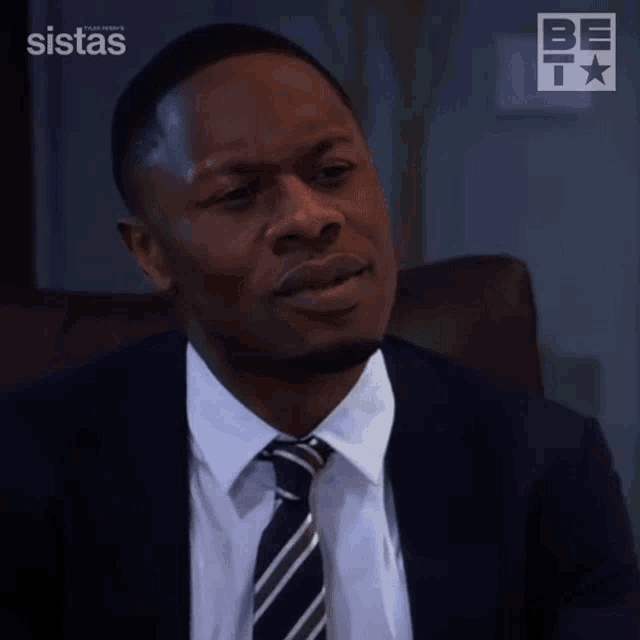 a man in a suit and tie with the word no on his face