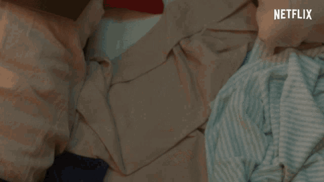 a woman laying on a bed with netflix written on the bottom