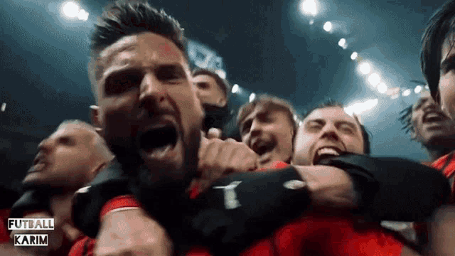 a group of soccer players are celebrating with the words futball karim in the background