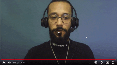 a man wearing headphones and a blessed t-shirt