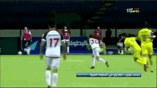a soccer player with the number 30 on his jersey kicks a ball