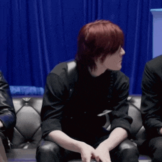 a woman with red hair is sitting on a couch