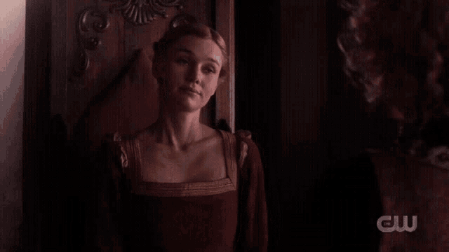 a woman says i accept your proposal in front of a wooden door