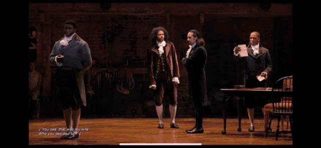 a group of men are standing on a stage and one of them says " you see that with my wife who you despised the most "