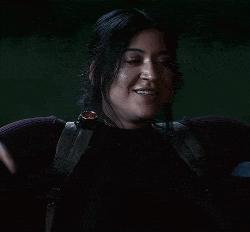 a close up of a woman wearing a watch and a sweater .