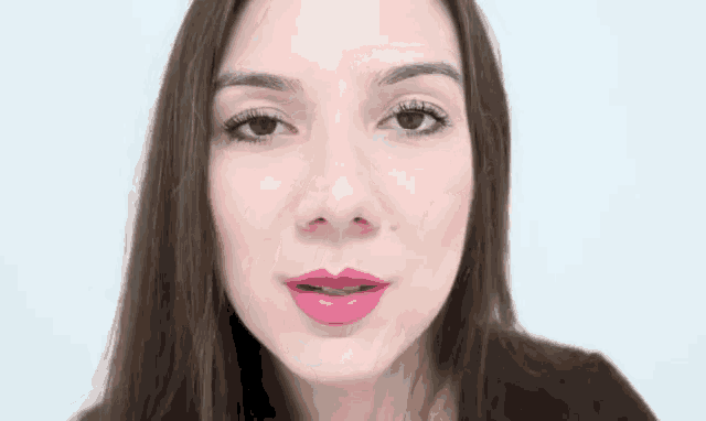 a close up of a woman 's face with a pink lip