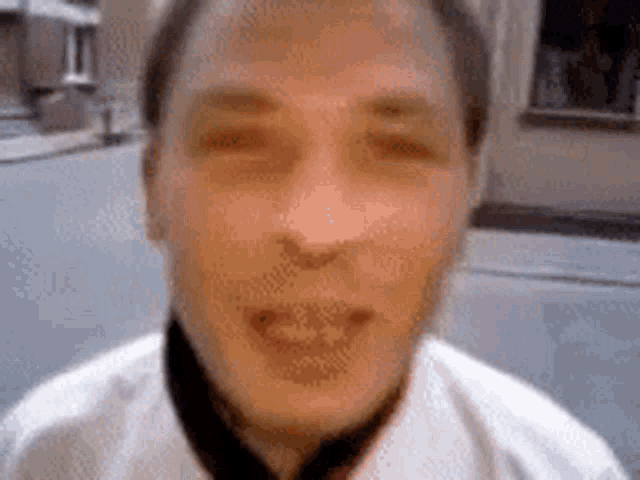 a blurry picture of a man 's face with a smile on his face .