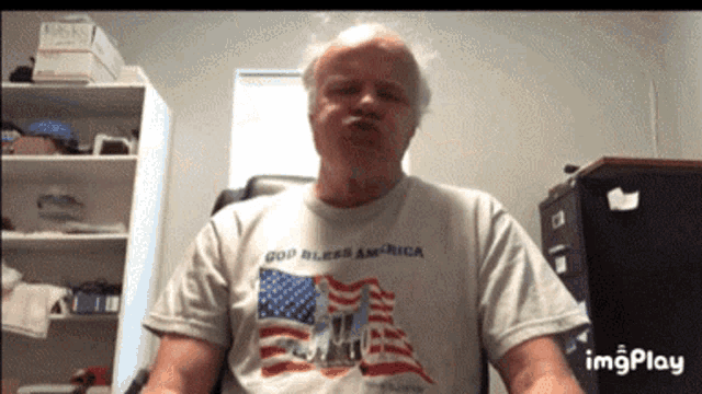a man is wearing a shirt that says god bless america on it