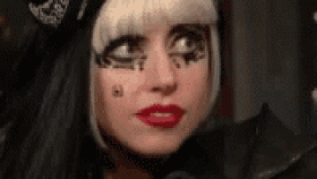 a close up of a woman 's face with makeup on it .