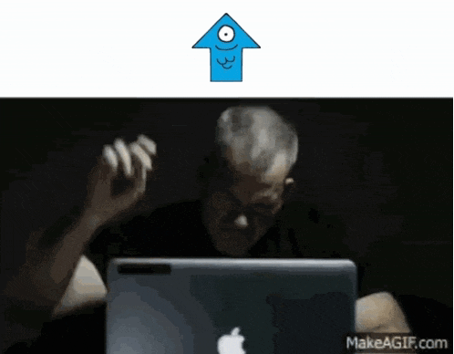 an older man sitting in front of an apple laptop