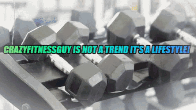 a bunch of dumbbells on a rack with the words crazyfitnessguy is not a trend its a lifestyle