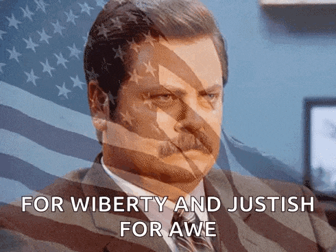 a man in a suit and tie says " for wiberty and justish for awe " in front of an american flag