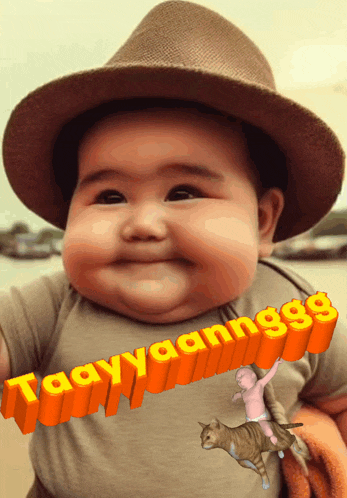 a baby wearing a hat and a shirt that says ' aayy aannggg '