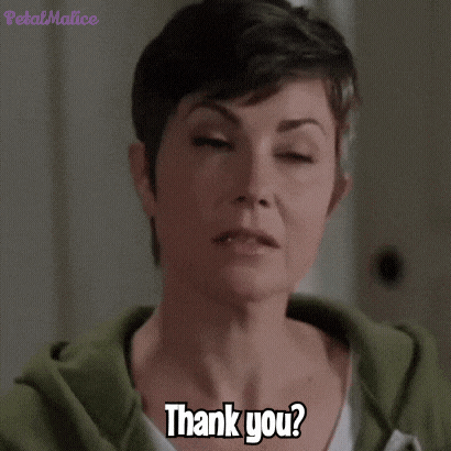a woman with short hair is saying thank you .