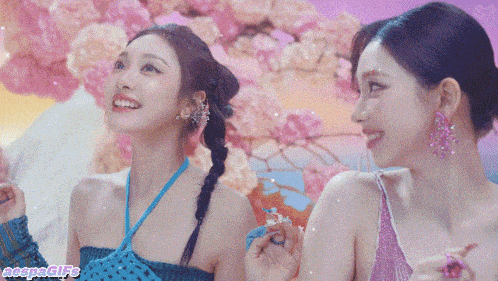 two women are standing next to each other with flowers in the background and a gif that says naeyon gifs