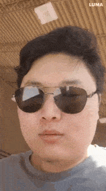 a man wearing sunglasses is taking a selfie .