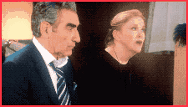 a man and a woman are standing next to each other