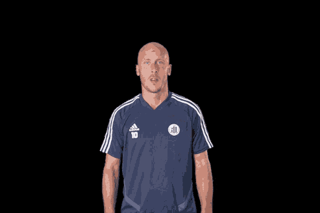 a man in a blue adidas shirt with the number 10 on it