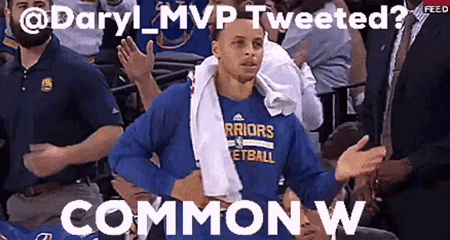 a man wearing a golden state warriors shirt is talking to someone in the crowd