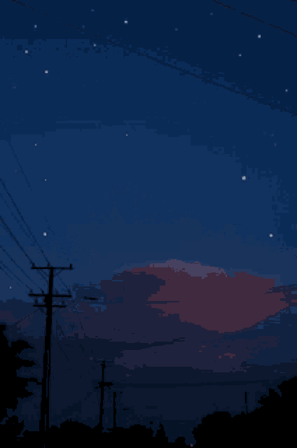 a shooting star is visible in the night sky above the telephone poles