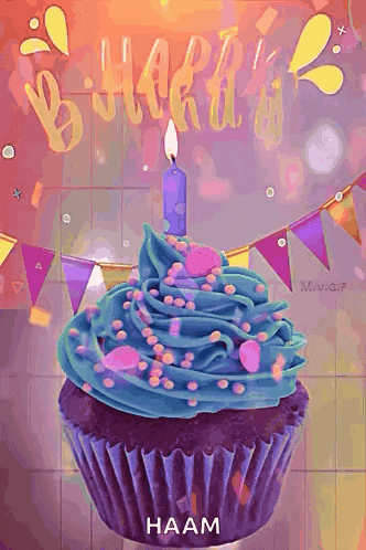 a cupcake with blue frosting and sprinkles has a lit candle on top