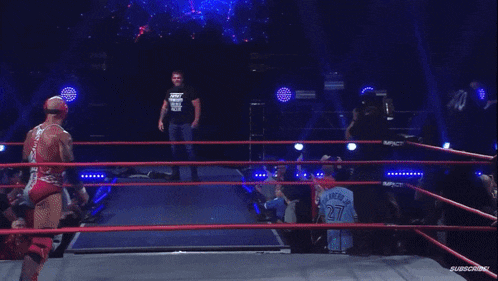 a wrestling match is going on in front of a sign that says emergence