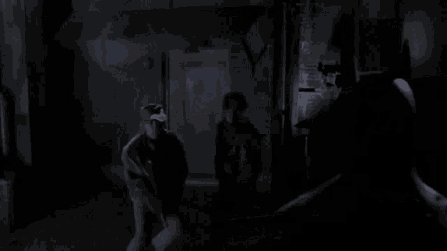 a person is standing in a dark room with a smoke coming out of the door .