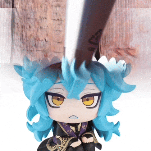 a figurine of a girl with blue hair and yellow eyes has a sword in her hand