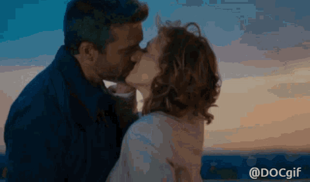 a gif of a man and woman kissing with the words docgif below them