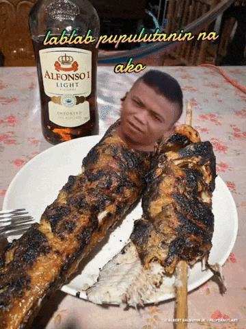 a bottle of alfonso light sits next to a plate of fish