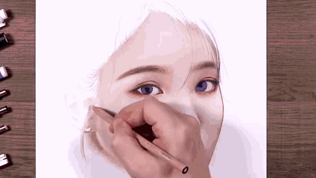 a person is drawing a portrait of a woman with blue eyes