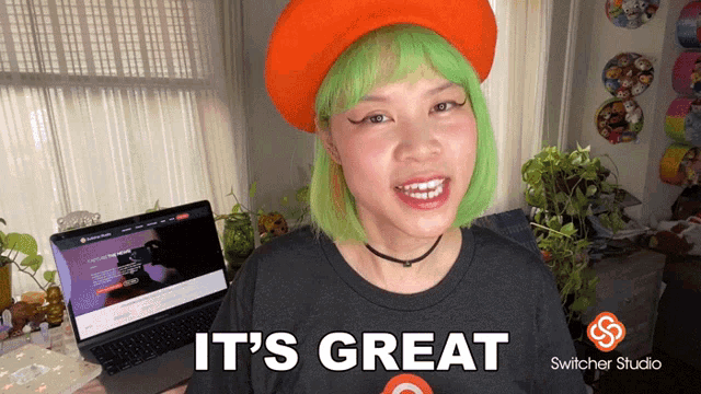 a woman with green hair and an orange hat says it 's great switcher studio