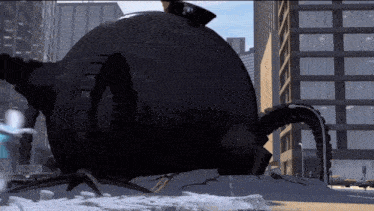 a large black object is in the middle of a city with a sign that says ' a ' on it
